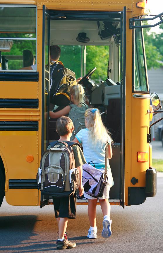 Students loading a school bus.