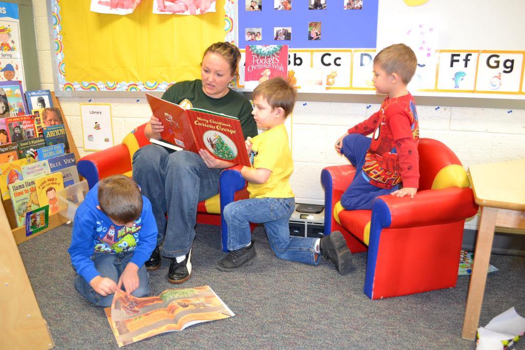teacher reading to preschool students